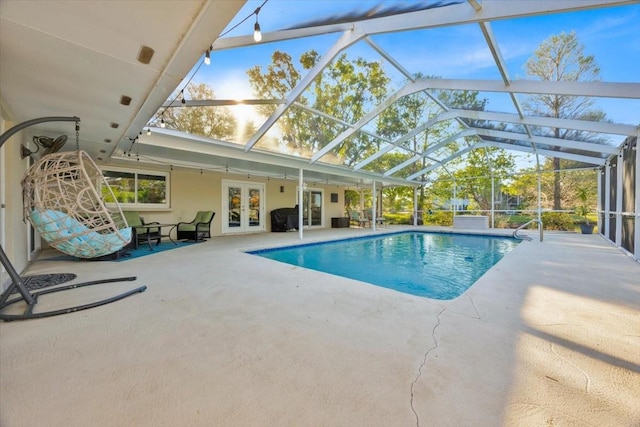 pool with french doors, a patio, a grill, and glass enclosure