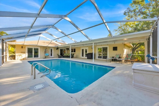 pool with a patio area, french doors, and a lanai