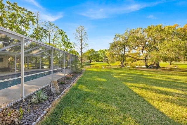 view of yard with glass enclosure