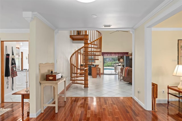 hallway with stairway, baseboards, wood finished floors, and ornamental molding