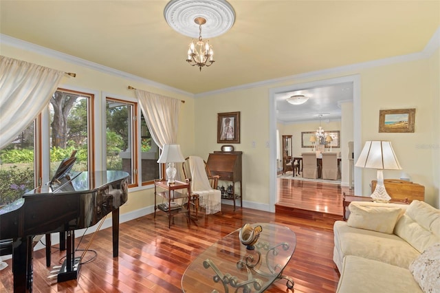 living room with a chandelier, wood finished floors, and ornamental molding