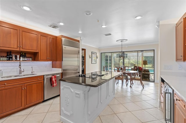 kitchen featuring beverage cooler, ornamental molding, appliances with stainless steel finishes, light tile patterned flooring, and a sink