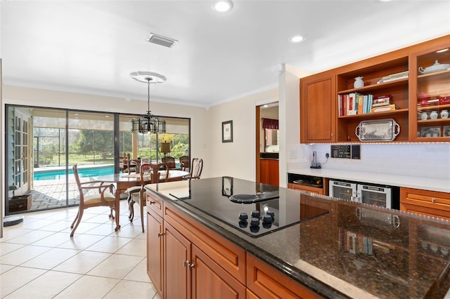 kitchen with brown cabinetry, visible vents, light tile patterned flooring, ornamental molding, and black electric cooktop