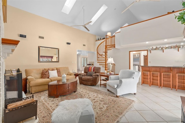 living room with stairs, a skylight, light tile patterned floors, and visible vents