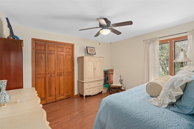 bedroom with a closet, a ceiling fan, and wood finished floors