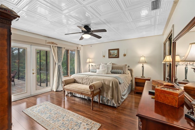 bedroom featuring visible vents, french doors, wood finished floors, an ornate ceiling, and access to outside