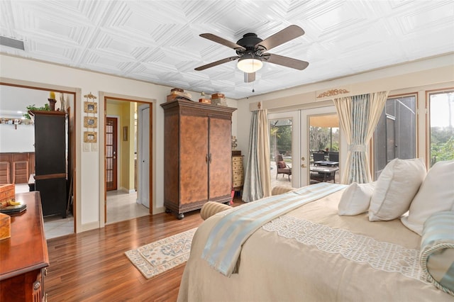 bedroom with access to exterior, multiple windows, french doors, and an ornate ceiling