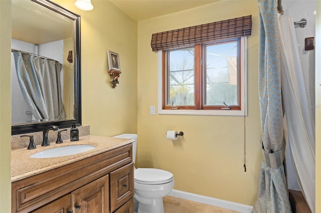 bathroom with tile patterned floors, toilet, a shower with shower curtain, baseboards, and vanity