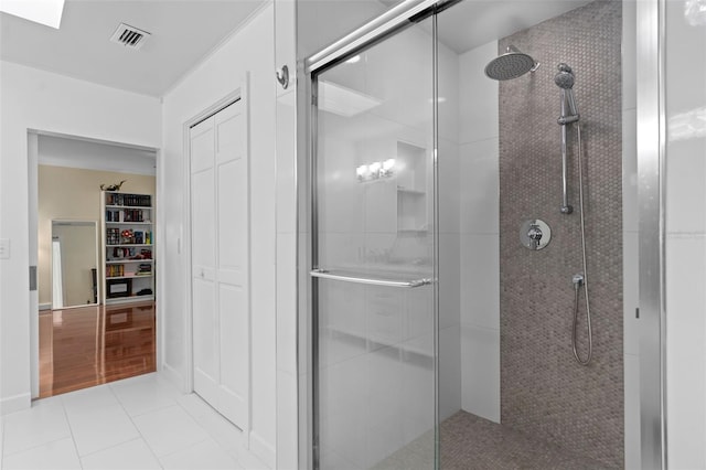 full bathroom with tile patterned floors, visible vents, a stall shower, and a closet