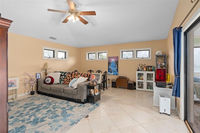 living room with light tile patterned floors, visible vents, lofted ceiling, and plenty of natural light