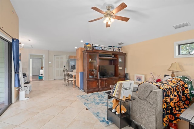 living area featuring light tile patterned floors, visible vents, and a ceiling fan