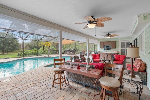 pool featuring an outdoor hangout area, a lanai, a ceiling fan, and a patio area