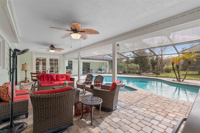 view of swimming pool with an outdoor living space, ceiling fan, a lanai, french doors, and a patio area