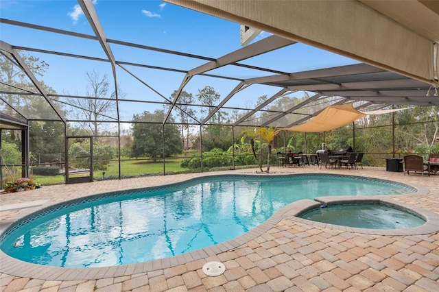 pool featuring a patio, an in ground hot tub, and a lanai