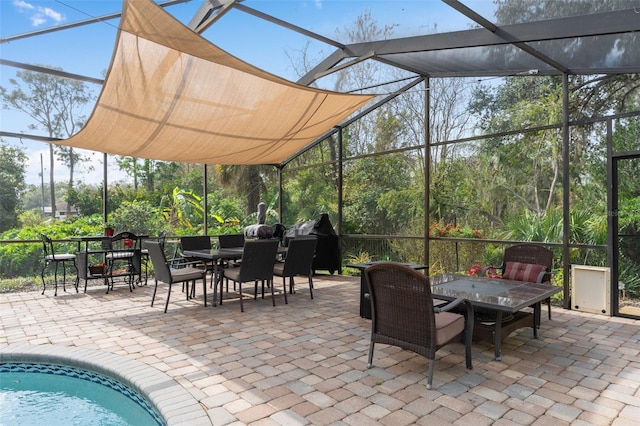 view of patio / terrace with outdoor dining space and glass enclosure