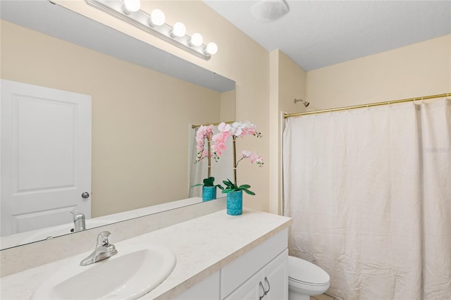 full bathroom with vanity, a shower with shower curtain, and toilet