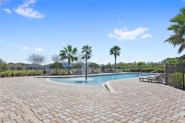 pool featuring a patio area and fence