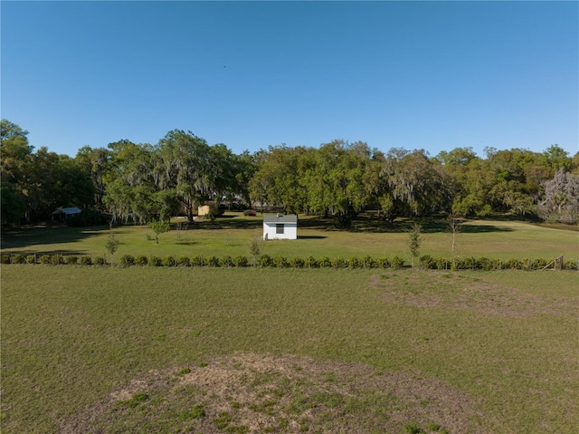 view of yard with a rural view and an outdoor structure