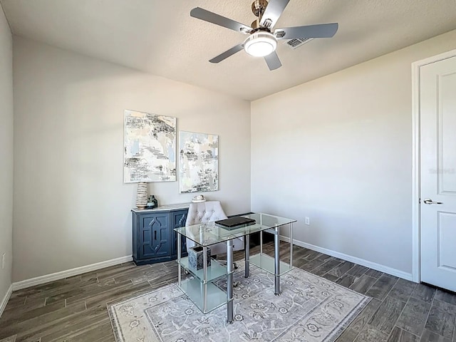 office with baseboards, dark wood-type flooring, and ceiling fan