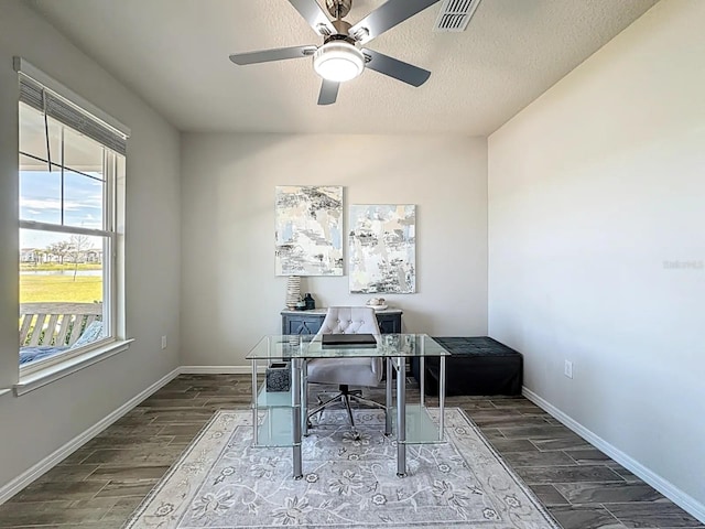 home office with baseboards, visible vents, and wood finish floors