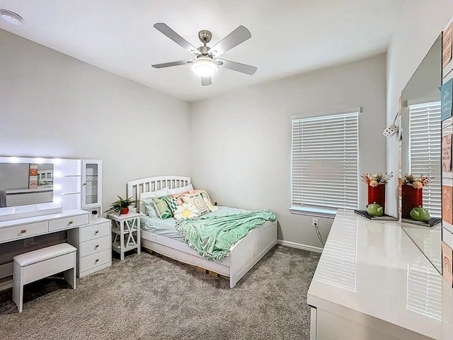 carpeted bedroom featuring baseboards and ceiling fan