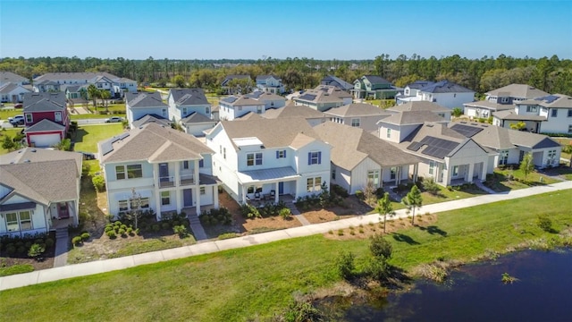 birds eye view of property with a residential view and a water view