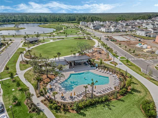 drone / aerial view with a water view and a residential view