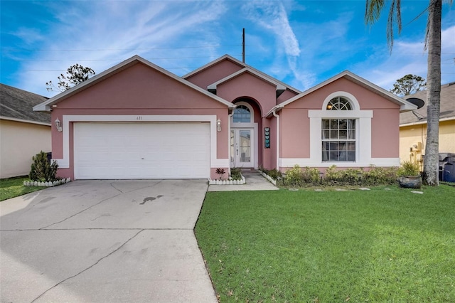 ranch-style home featuring a front yard, an attached garage, driveway, and stucco siding