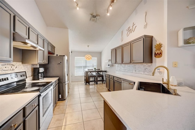 kitchen featuring visible vents, a sink, under cabinet range hood, appliances with stainless steel finishes, and light tile patterned floors