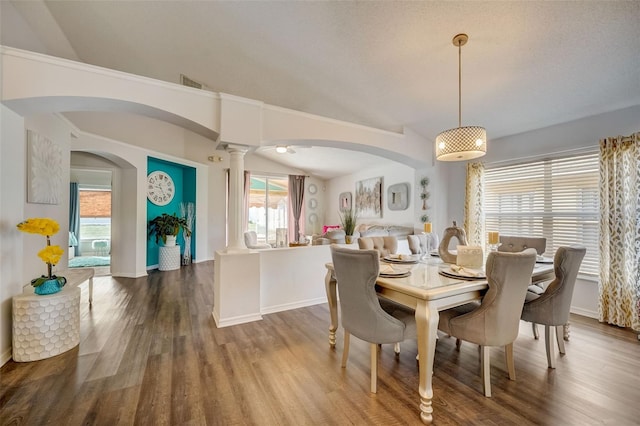 dining room with visible vents, arched walkways, wood finished floors, and ornate columns