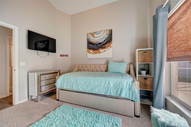 bedroom with baseboards and carpet