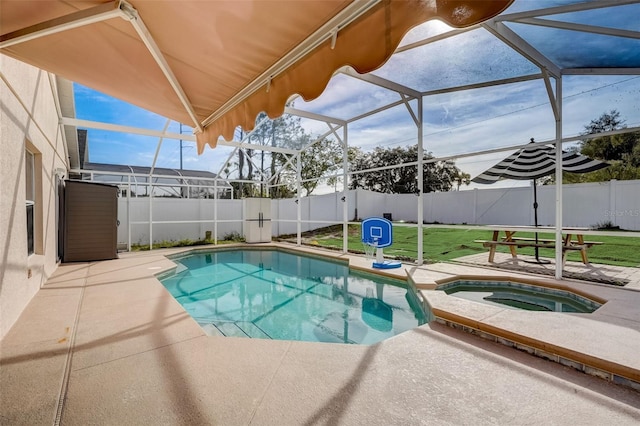 view of swimming pool featuring glass enclosure, a fenced backyard, a pool with connected hot tub, a patio area, and a lawn