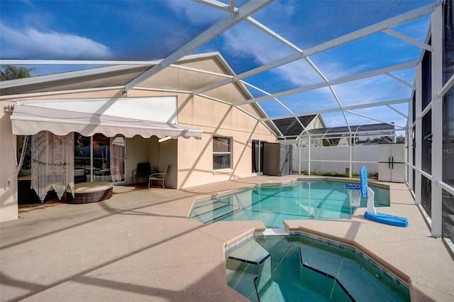 view of pool featuring a patio, a pool with connected hot tub, and a lanai