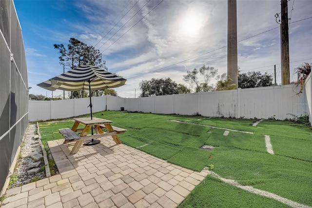 view of yard with a fenced backyard and a patio area