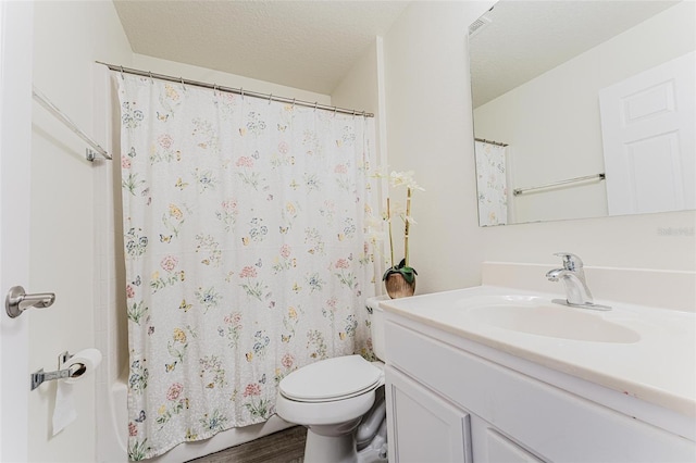 bathroom featuring vanity, wood finished floors, a textured ceiling, toilet, and shower / tub combo with curtain