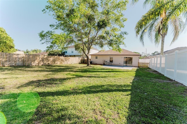 view of yard with a patio area and a fenced backyard