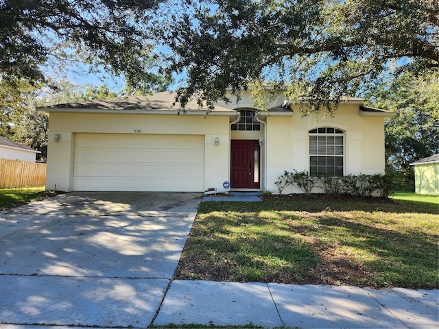 single story home with a front lawn, fence, concrete driveway, stucco siding, and a garage