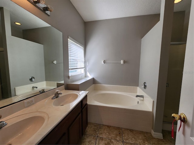 bathroom featuring a sink, a garden tub, double vanity, and tile patterned floors