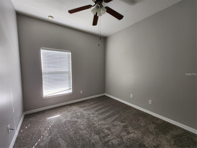 carpeted spare room featuring a ceiling fan, baseboards, and a textured ceiling