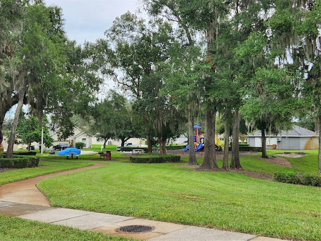 view of community featuring a lawn and playground community