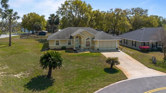 single story home featuring stucco siding, a front lawn, driveway, fence, and a garage