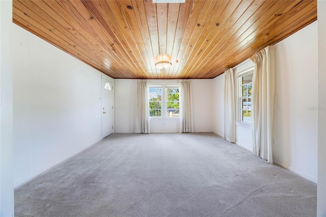 unfurnished room featuring light carpet and wooden ceiling