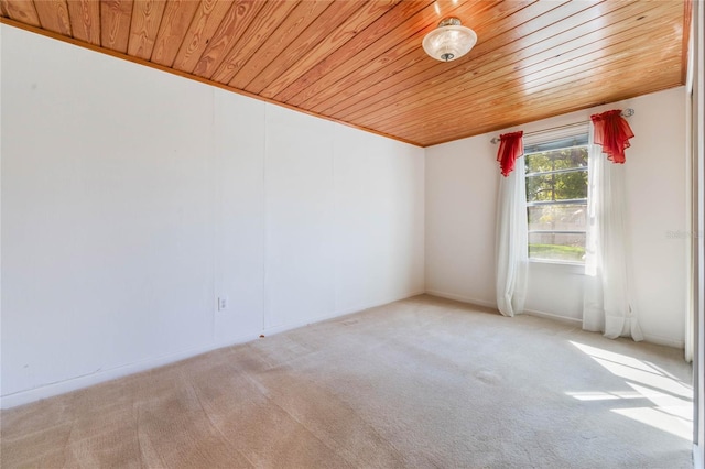 carpeted spare room with wooden ceiling