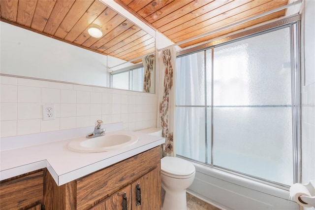 bathroom featuring vanity, shower / bath combination with glass door, wooden ceiling, toilet, and tile walls