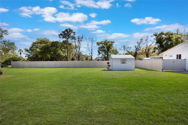 view of yard featuring an outbuilding, a storage shed, and a fenced backyard