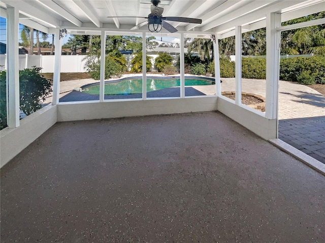 unfurnished sunroom featuring a ceiling fan