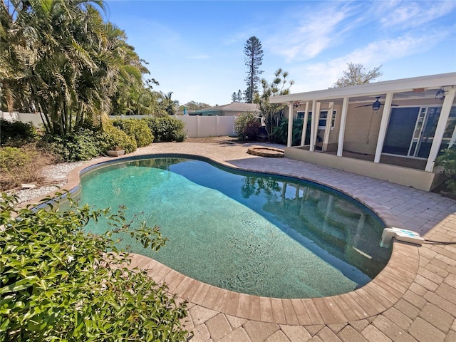 view of swimming pool featuring a patio area, a fenced in pool, a fenced backyard, and ceiling fan