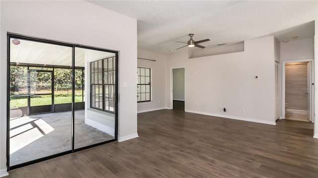 spare room featuring baseboards, wood finished floors, and a ceiling fan