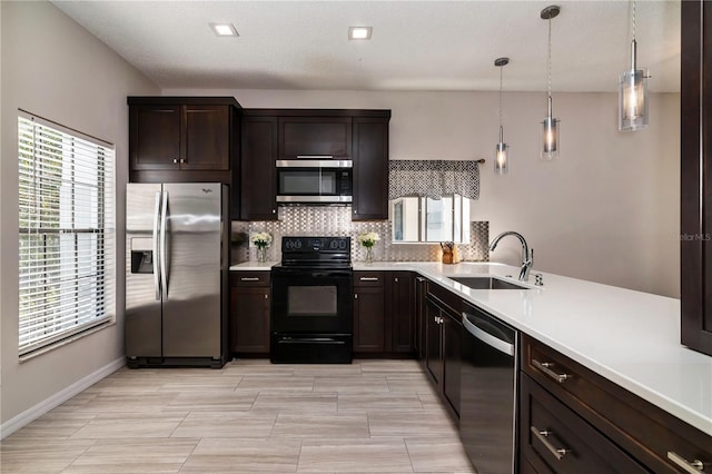 kitchen with a sink, dark brown cabinetry, light countertops, appliances with stainless steel finishes, and tasteful backsplash