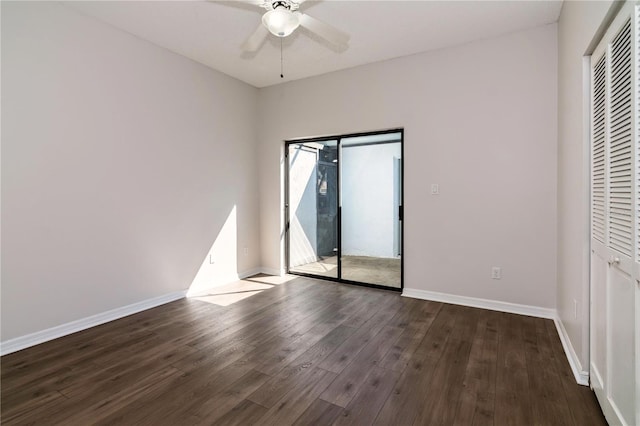 unfurnished bedroom featuring a closet, baseboards, wood finished floors, and a ceiling fan